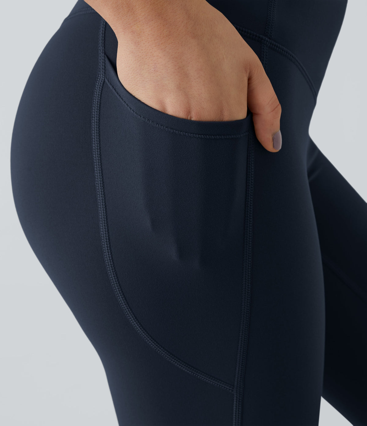 Close-up of the side pocket on Celeste L'Amour Carbon leggings with a hand tucked inside
