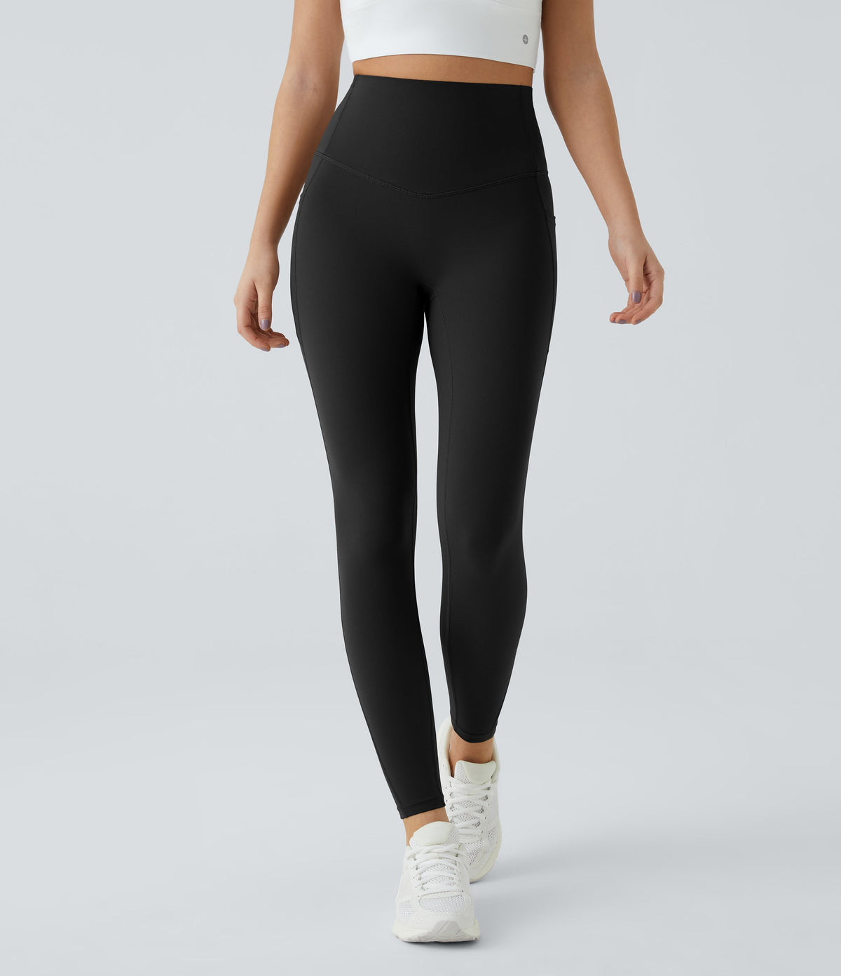 Front view of Celeste L'Amour Black high-waisted 7/8 leggings shown on a model mid-stride