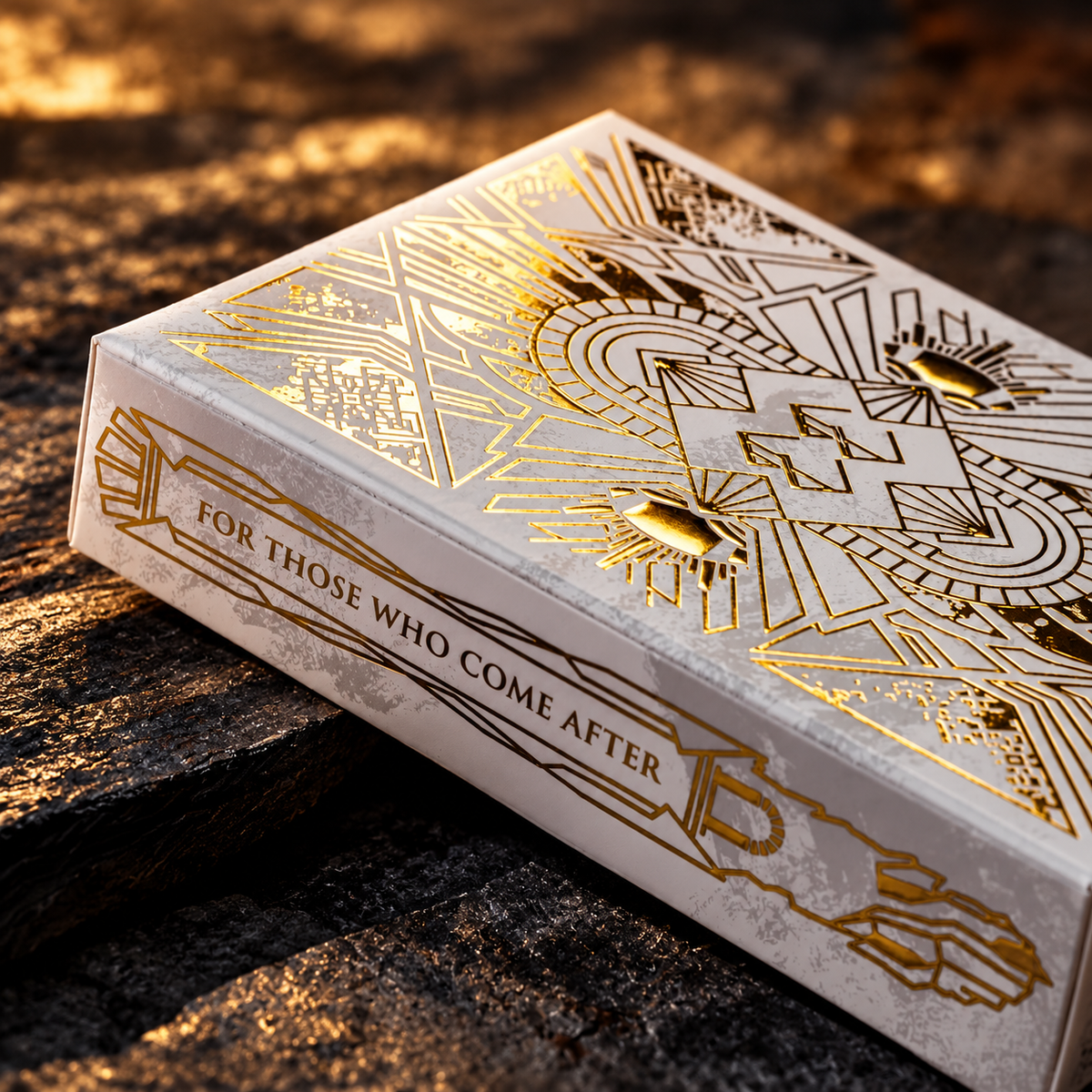 Close view of gold foil linework on the ivory tuck box
