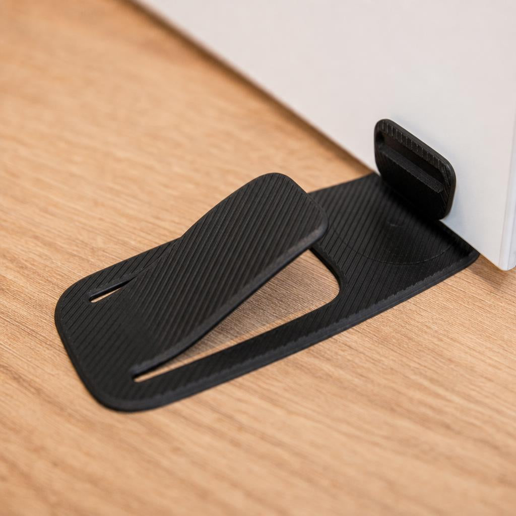 Close-up of the door stopper under a white door