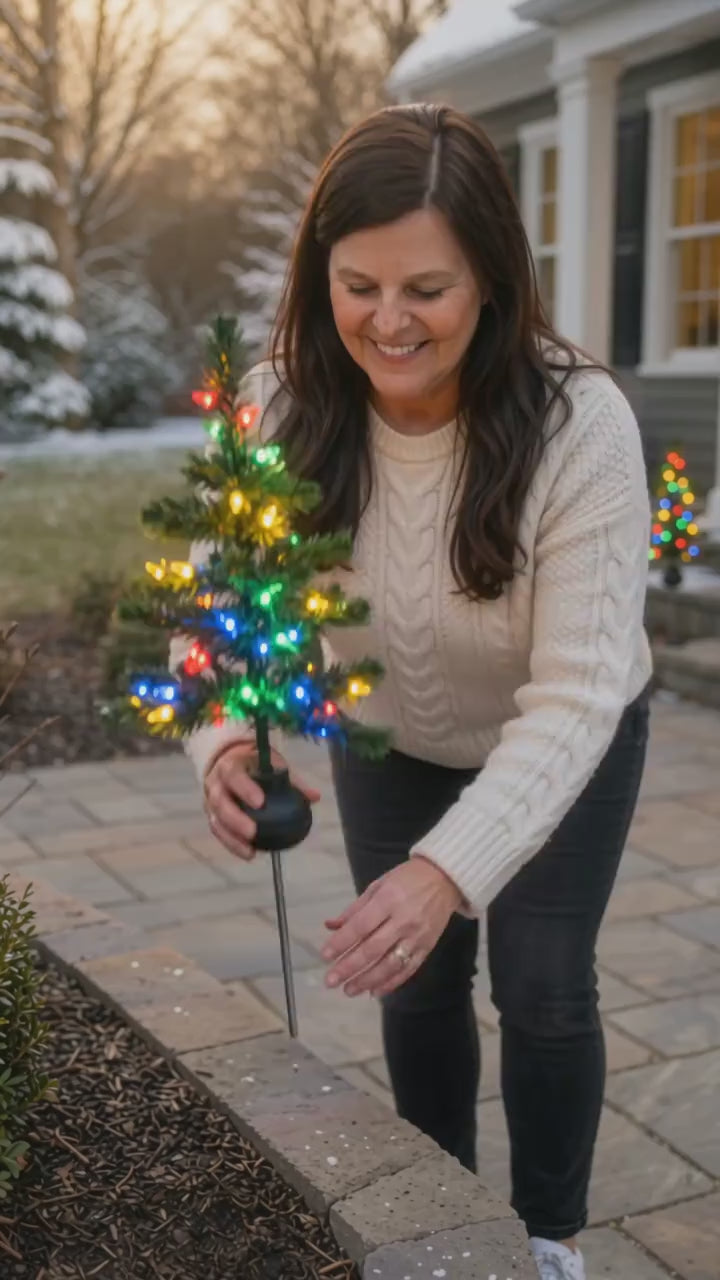 Solar Christmas pathway tree displayed in a winter front yard